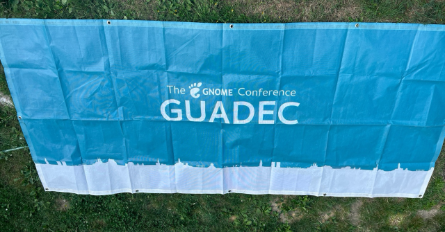 A GUADEC (The GNOME Conference) light blue banner.