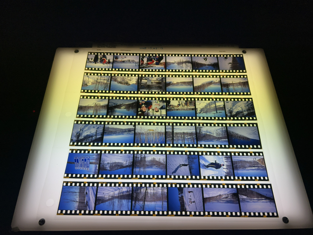 Strips of slide film on the light table. It’s hard to see be they are upside down.