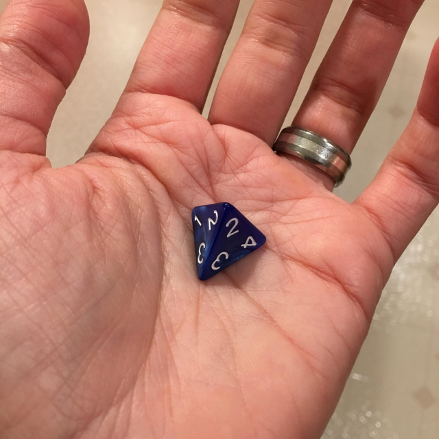 A four sided die. It’s like a little pyramid of pain. 