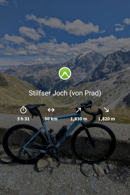 A blue road bike on top of a mountain pass, the valley in the background. The picture is overlayed with some stats. 3h31, 50km, 1830 meters of climbing. 