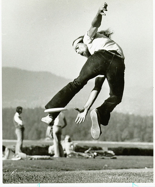 Ken Westerfield making a leaping catch of a frisbee, backwards and between the legs