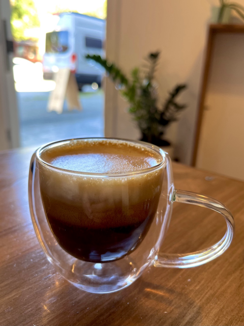 Cappuccino in a transparent coffee glass 