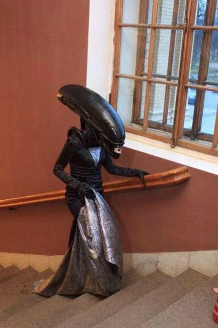 the xenomorph with breasts, a suit, and a blanket