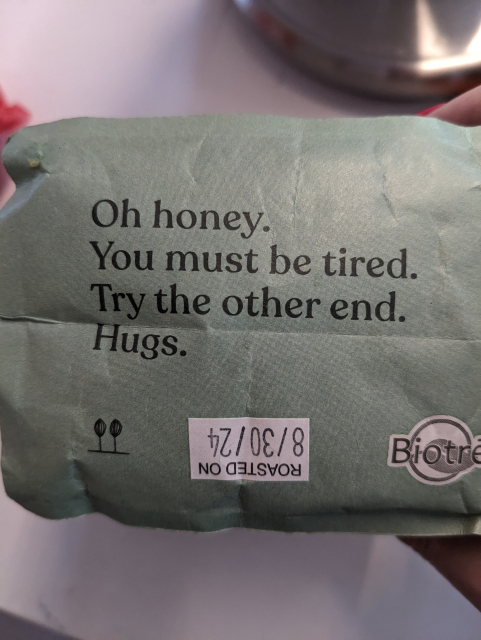 the bottom of a bag of coffee beans reading "oh honey, you must be tired. try the other the. hugs "