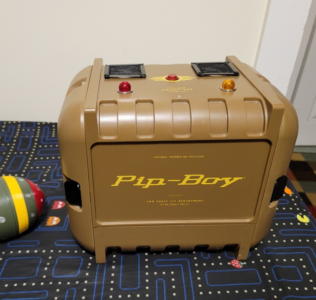 A Fallout Pip-Boy case. There are two small fans ports a button and two lights on top. Like, you know, there might be a PC inside it.