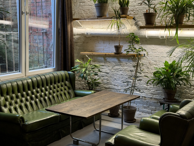 Green sofas and plants in an industrial atmosphere