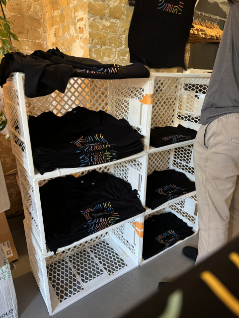 A picture of Matrix Conference t-shirts stacked on racks