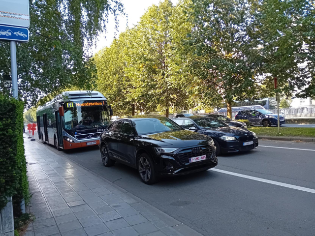 Black Audi SUV parked on a bus stop.