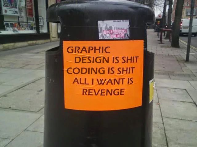 An orange piece of paper glued to a litter box saying in bold black letters: graphic design is shit, coding is shit, all i want is revenge