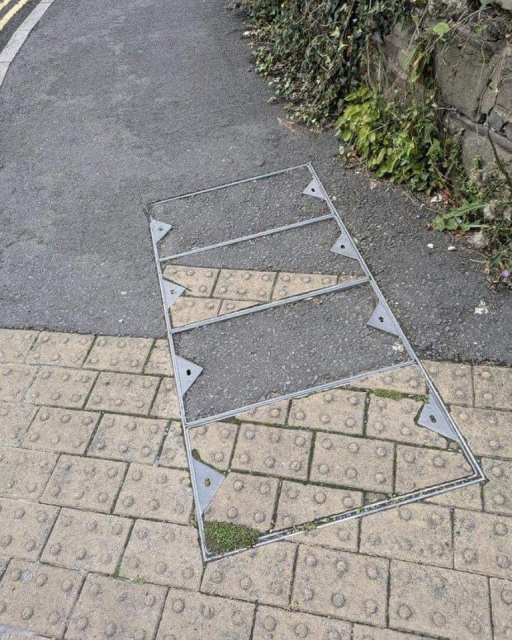 pavement and roadwork with some misplaced paneling covering underlying infrastructure