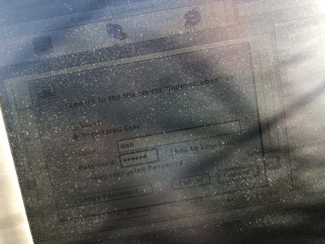 A Mac OS 9 choose window showing a server being connected to. Over barbed wire. 