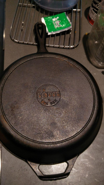 A Lodge no.5 cast iron pan, made in the USA, with some rust on it