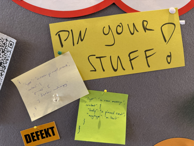 A sticky note with “Pin your stuff!” written on it; and two sticky notes with json objects corresponding to Matrix events for sticky messages