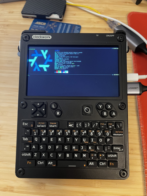 Black uconsole a cyber deck handle held computer, running nixos with lix