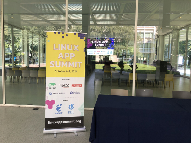 Banner for the Linux App Summit in front of the conference venue.