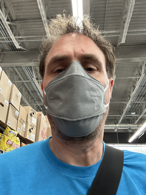 A selfie of myself in a store wearing a gray face mask.