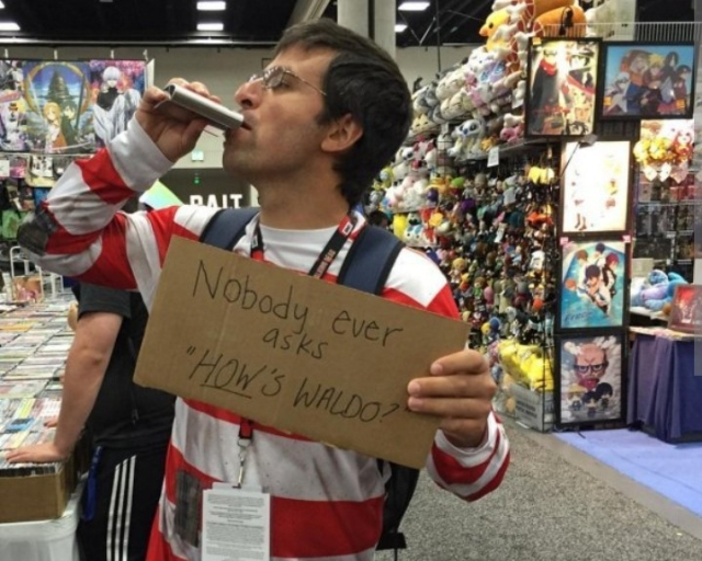 Waldo drinking holding sign stating nobody asks "How's Waldo?"