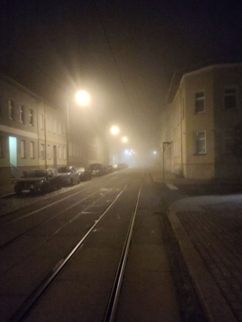 Yet another foggy street with tram tracks.