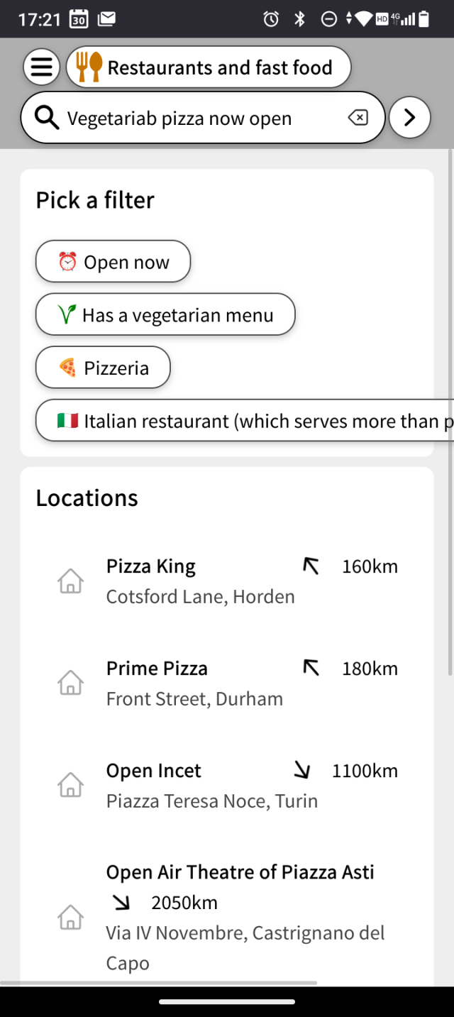 The search menu. The user typed 'vegetarian pizza open now'. MapComplete offers the filters 'open now', 'pizzeria', 'italian restaurant' and 'has a vegetarian menu'