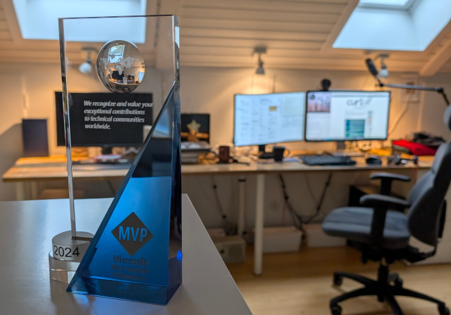 A glass "trophy" from the Microsoft MVP program. The engraved text says "We recognize and value your exceptional contributions to technical communities worldwide"