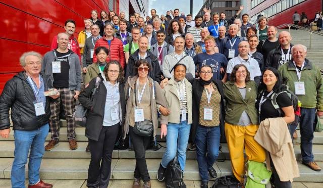 Photo of community members on steps in front of the venue