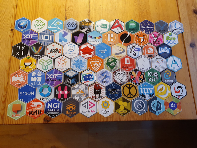 A collection of hexagonal stickers on a wooden table.