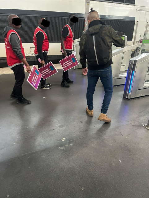 3 guys with don’t forget luggage signs 