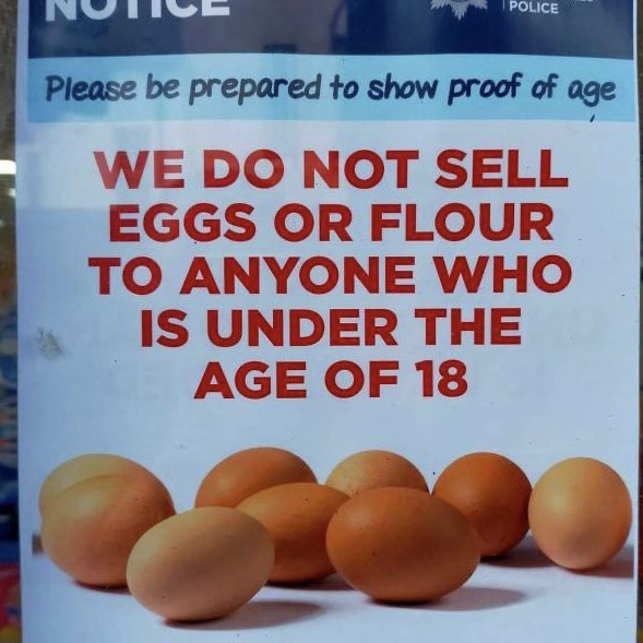 Sign in store window reads “we do not sell eggs or flour to anyone who is under the age of 18.”