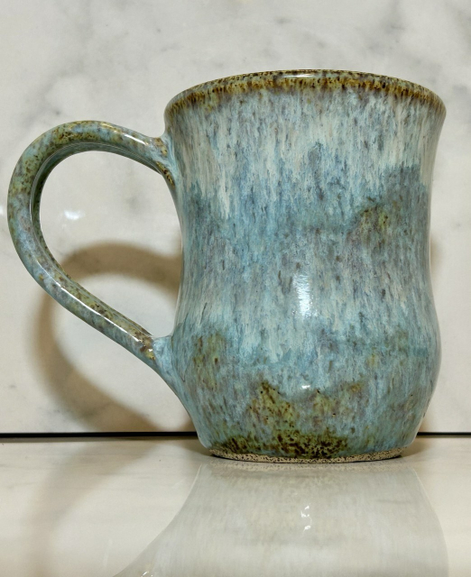 A blue handmade ceramic mug.