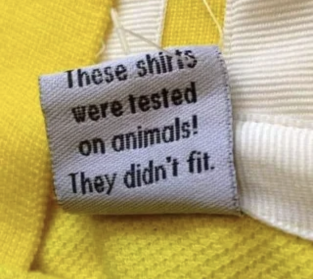 A tag on a shirt reading: "These shirts were tested on animals! They didn't fit."