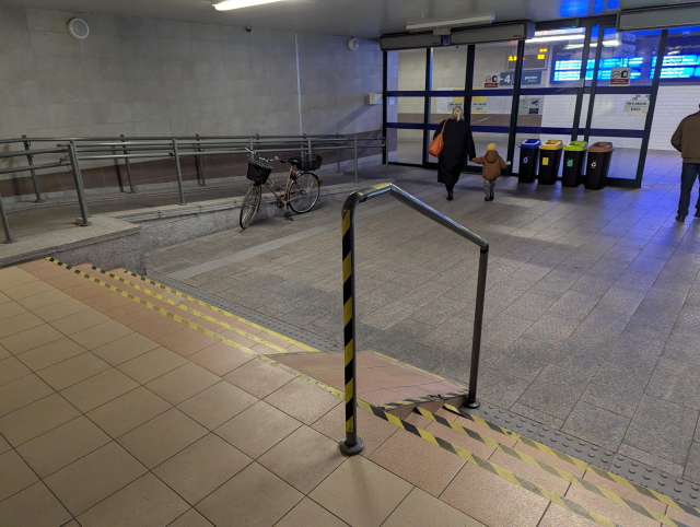 A extremely steep ramp on a staircase of three stairs.