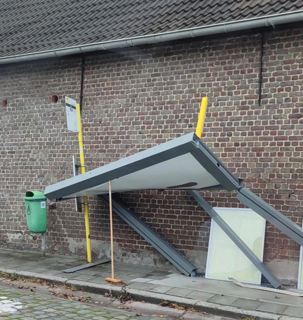 Bus stop barely falling down with curved roof