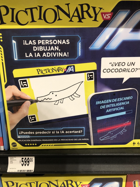 Caja a la venta del juego Pictionary, versión "las personas dibujan, la IA adivina". Hay que conectarlo a una maldita aplicación que escanea tus garabatos y los manda a una IA. "¿Puedes predecir si la IA acertará?"