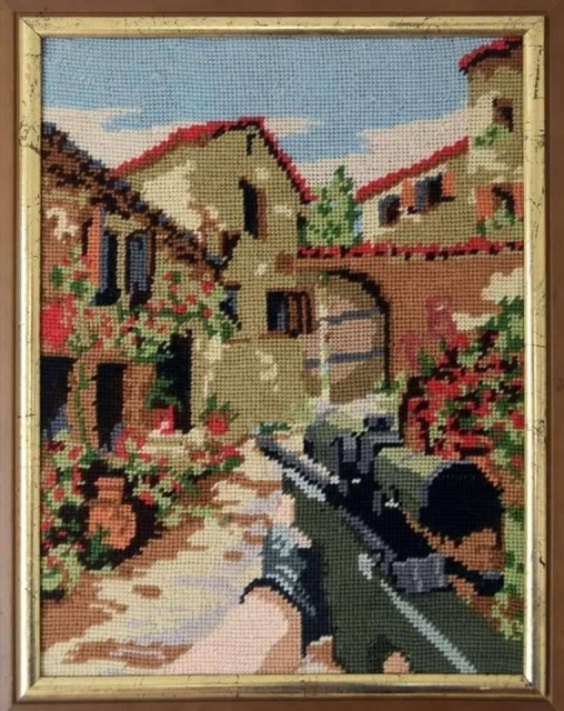 Cross stitch of a scenic, Spanish style village, but with someone's hand holding a sniper rifle like in a FPS game.