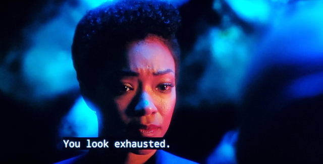 Star Trek Discovery scene between Michael Burnham (human) and Saru (alien largely humanoid in structure and v tall with no hair and lots of wavy facial loaf and lines, clearly not from earth) We're somewhere off ship and it's nighttime. The background of the scene is maybe a cave or the interior of a or something. 
Picture 1: Michael Burnham is pictured in uniform, she looks looks strained. Closed caption reads, "You look exhausted."
Picture 2 & 3 is on Saru. He's sitting and holding a hand to the side of his face, with a pained exhausted expression. Closed caption reads, "It's the constant noise generated by this planet."