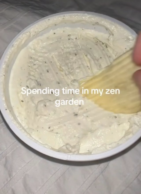 somebody using a ridged potato chip to make rake like designs in a plate of dip. Caption says, Spending time in my zen garden.