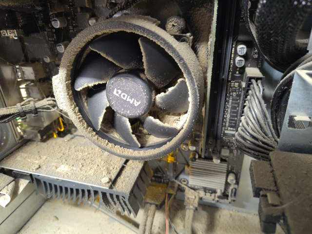 The internals of a particularly caked in dust and grime computer