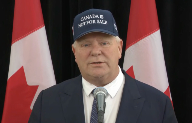It's Ontario premier Doug Ford delivering a press conference with a MAGA-style "CANADA IS NOT FOR SALE" hat on