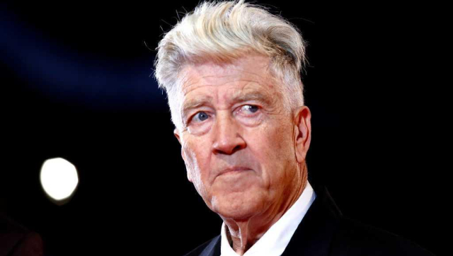 picture of a white man with white hair in a black suit and white shirt