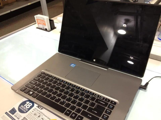Picture of an Acer Aspire R7. While looking mostly like a normal laptop, rather unusually the touchpad sits above the keyboard instead of below.