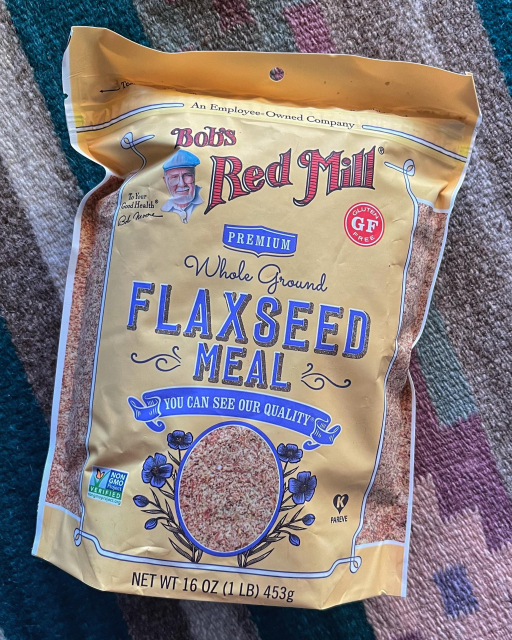 A 1-pound package of Bob’s Red Mill Whole Ground Flaxseed Meal lying face-up on a table.