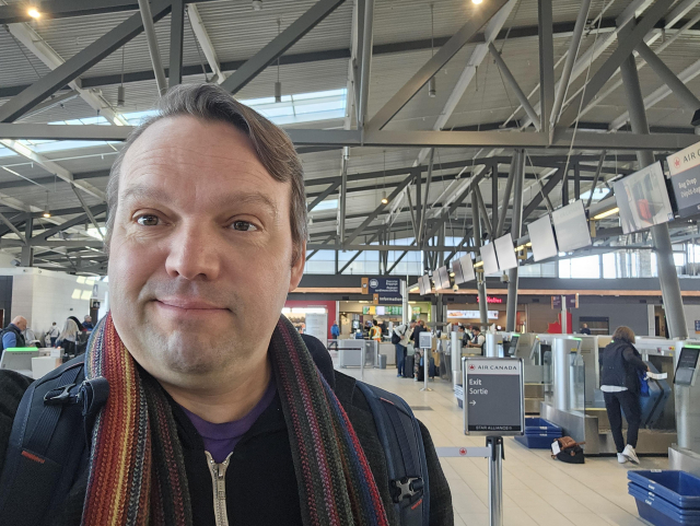 Me with a goofy smile at airport.