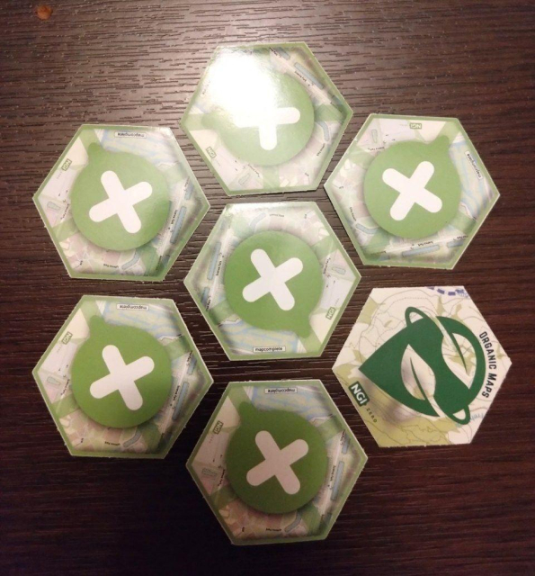 Hexagonal MapComplete stickers, laid in a hexagonal pattern, every sticker rotated at a different angle. One of the stickers is for Organic Maps though.