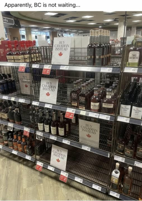  A liquor store shelving with big empty spots showing a sign that says "Buy Canadian Instead" and a maple leaf logo. 