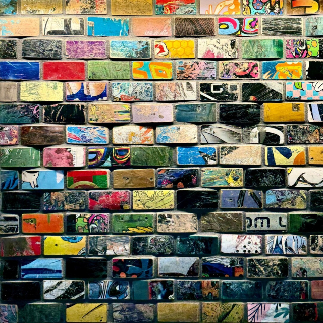 Bricks/tiles all painted in different ways in a variety of vivid colors