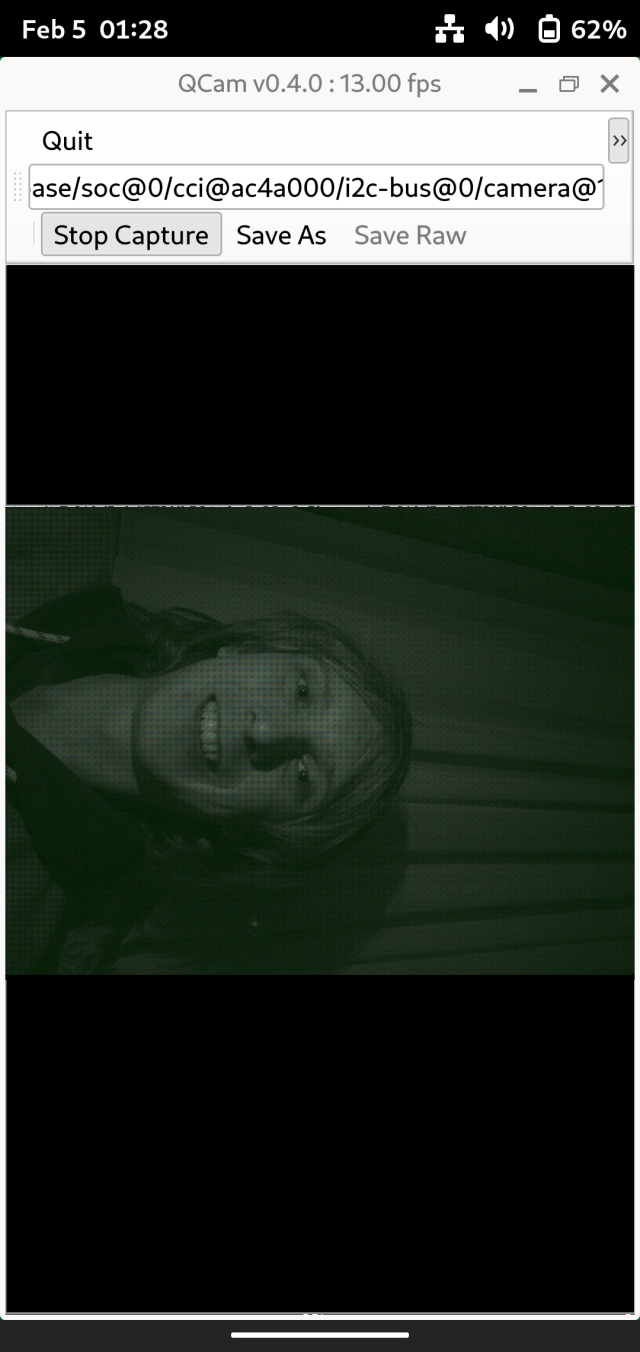 A screenshot of qcam running on a OnePlus 6, the selfie camera is open with my face sideways, everything is tinted green