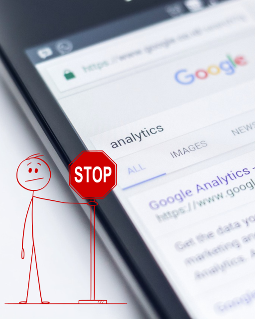 Man holding up a stop sign in front of screen with Google analytics.