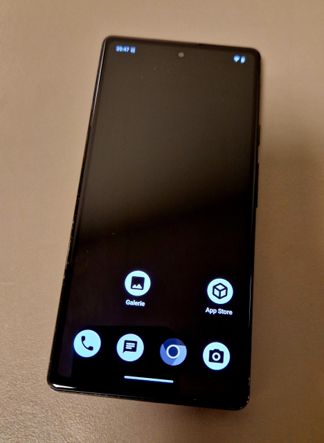 A phone with the home screen of GrapheneOS. The UI is black and white and there are 6 icons on the screen.