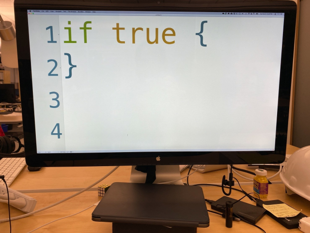 Photo of a computer monitor showing computer code with the code “if true {}” in giant letters. (It’s a pun.)