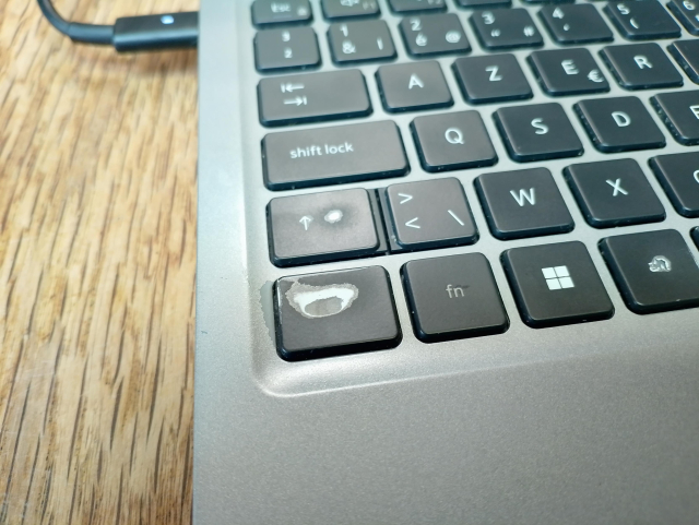 A closeup of a computer keyboard. The CTRL-key is worn out, the paint is gone in the middle